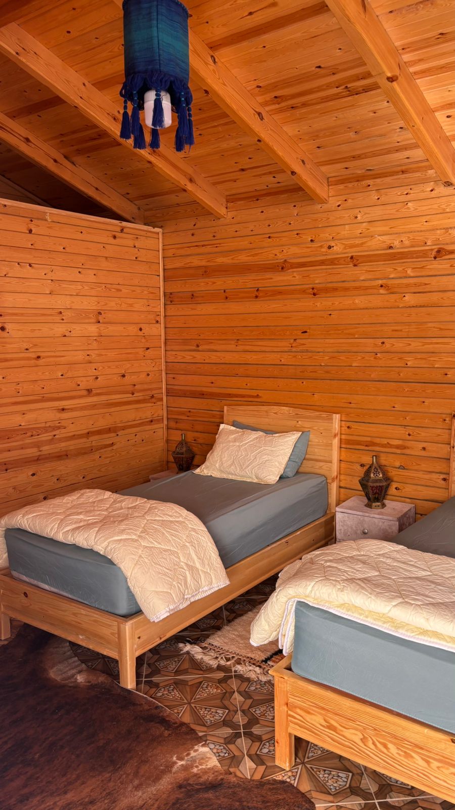 Wooden cabin twin beds with lantern